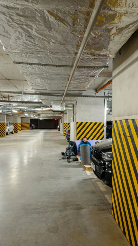 a empty warehouse with some cars parked in it