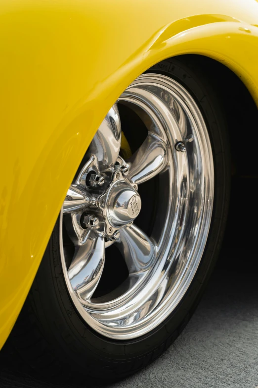 the front wheels of a yellow sports car