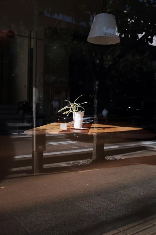 a flower pot on a small wooden table