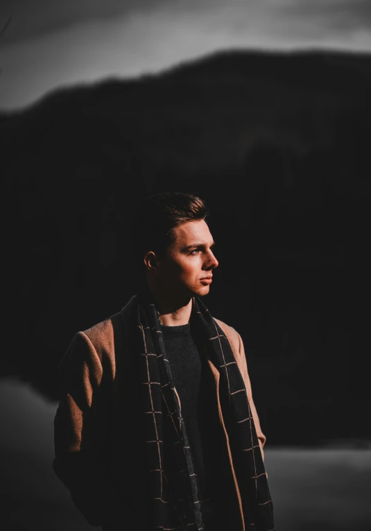 man in a dark room with dark backdrop