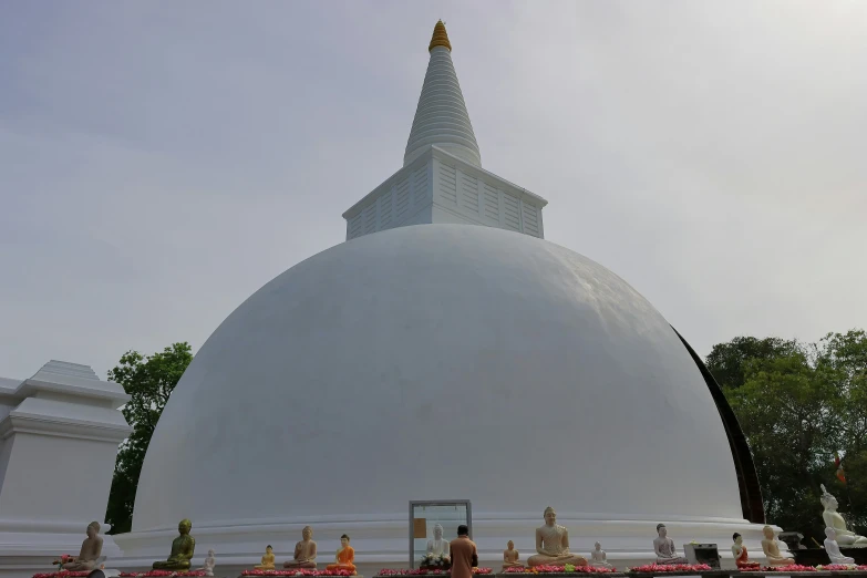 the white pagoda is in the middle of the garden