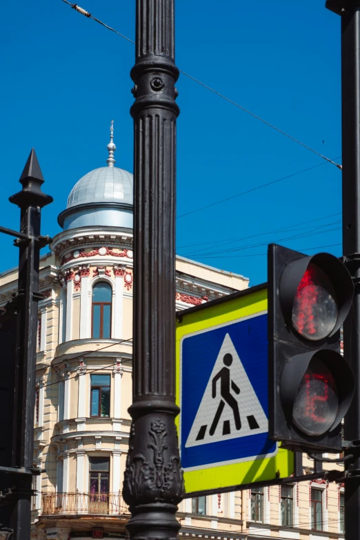 there is a blue and yellow street sign on the pole