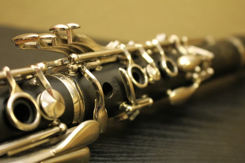 a flute rests on a table beside a phone