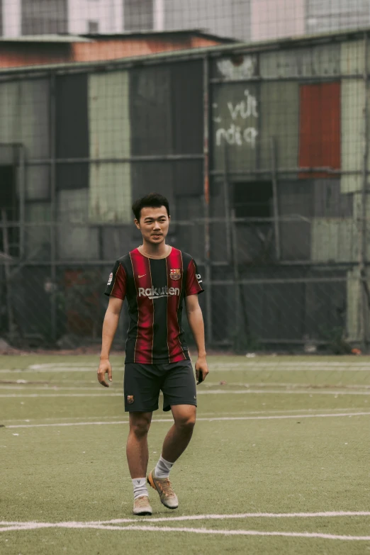 an asian soccer player in the middle of a ball play