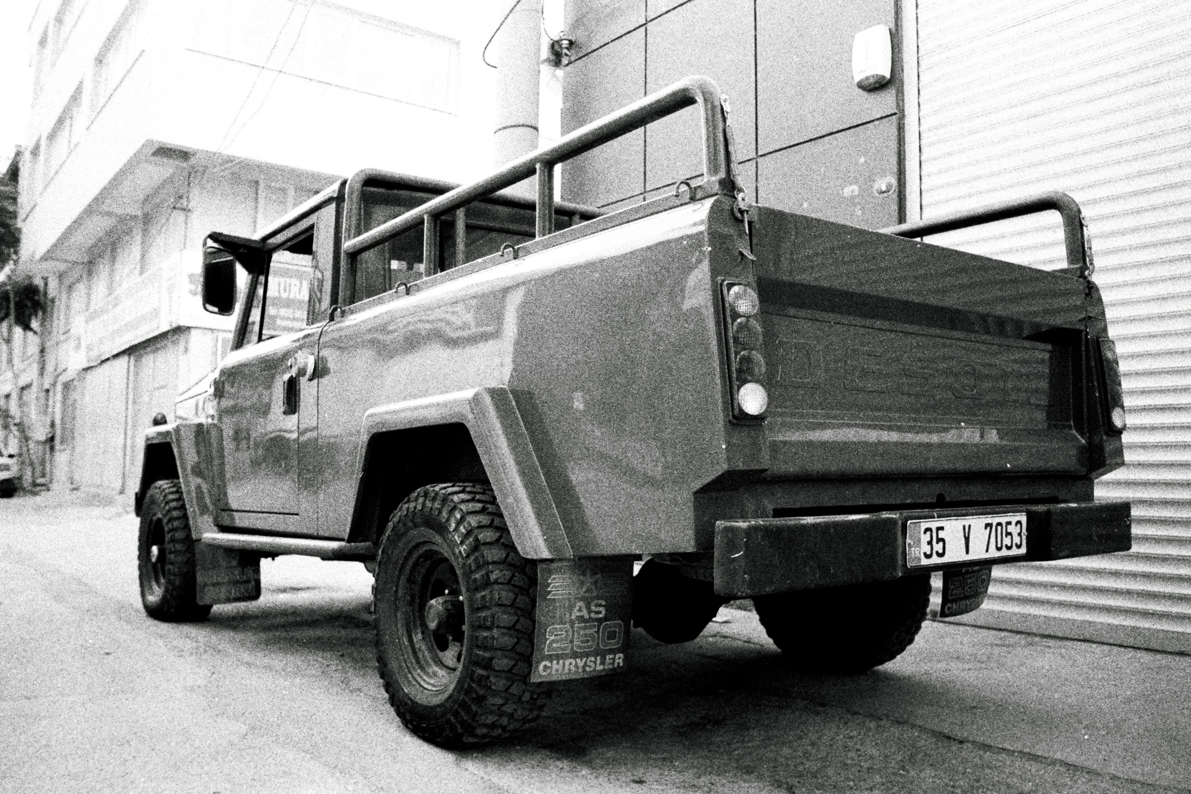 an old military truck parked on the street