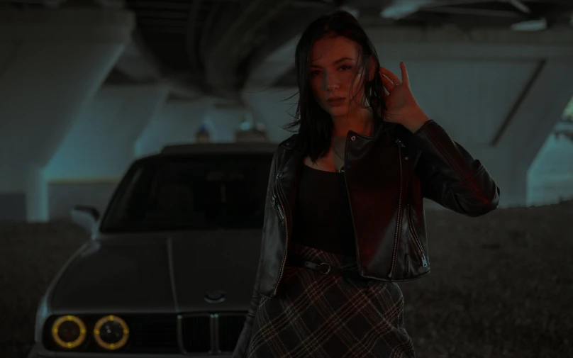 a woman standing by a parked car and talking on a cell phone