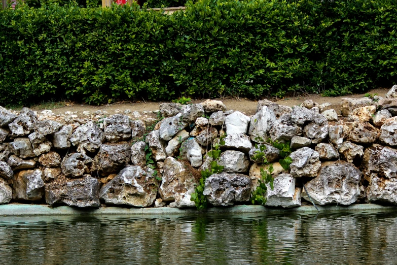 there are several rocks in front of the water