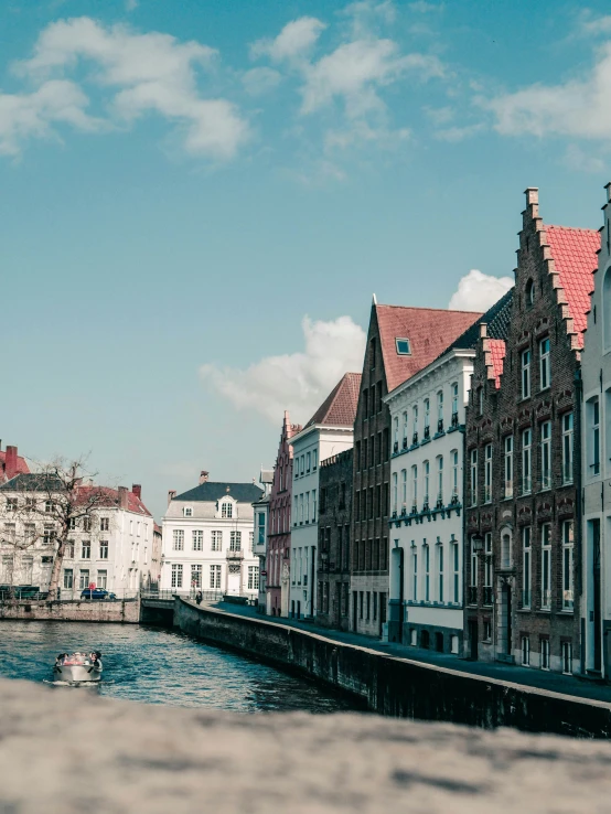 a narrow canal is lined with tall buildings