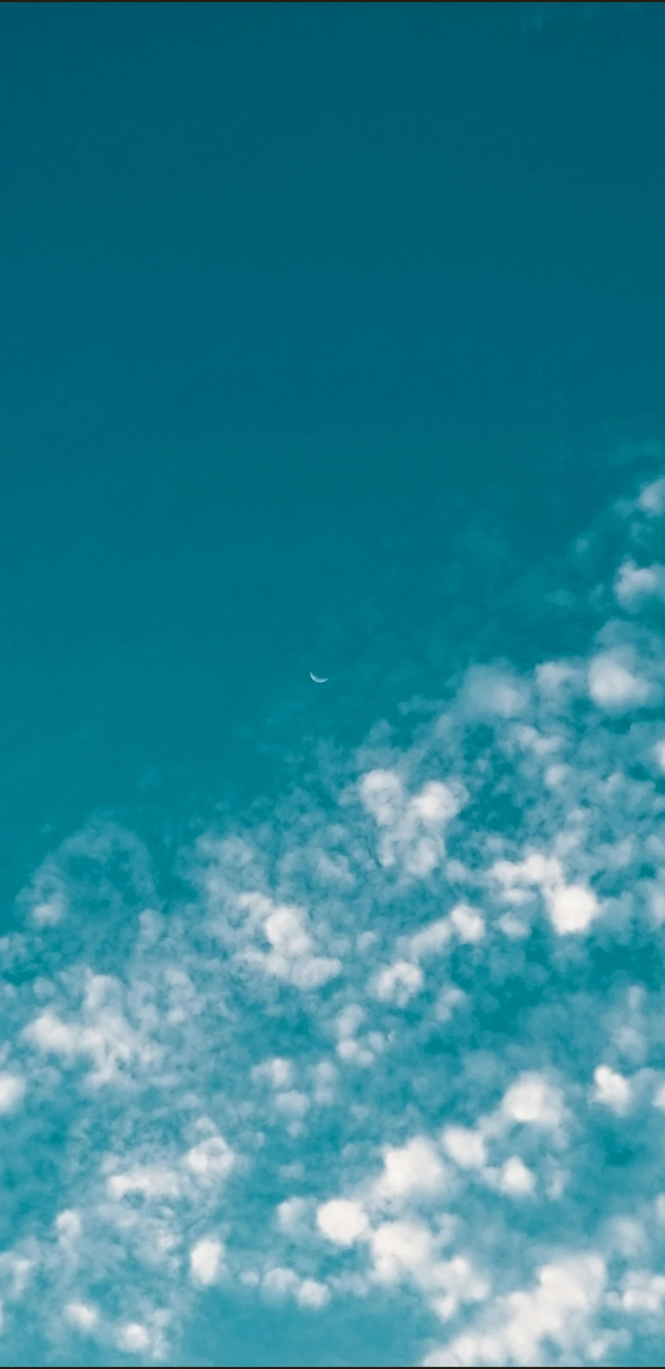 a plane flying in the sky covered in clouds