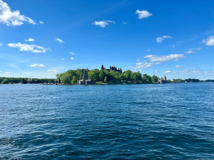 the castle sits on top of the hill over the water