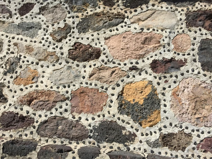 a rock surface with lots of different colored rocks on it