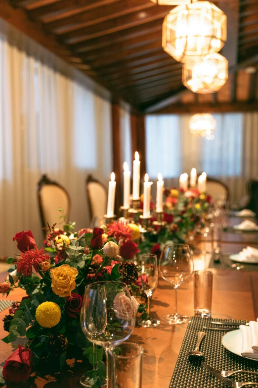 a long wooden table topped with lots of flowers