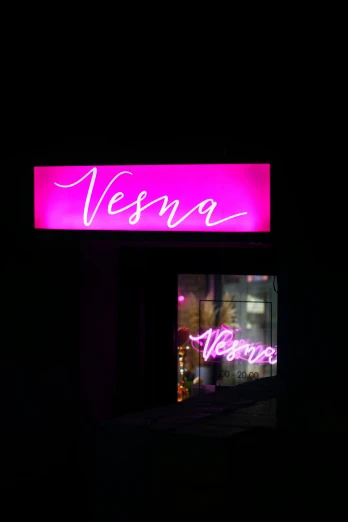 purple neon sign lit up in the dark for the store