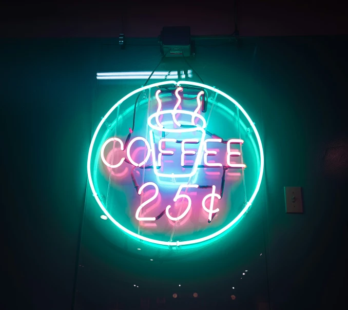 a neon sign with a cup of coffee painted on it