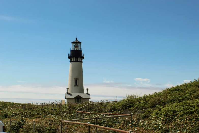 the large lighthouse is located on a small hill