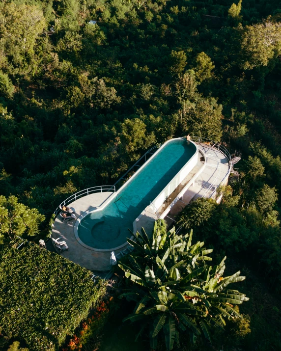 an aerial view of an aerial pool in a forest