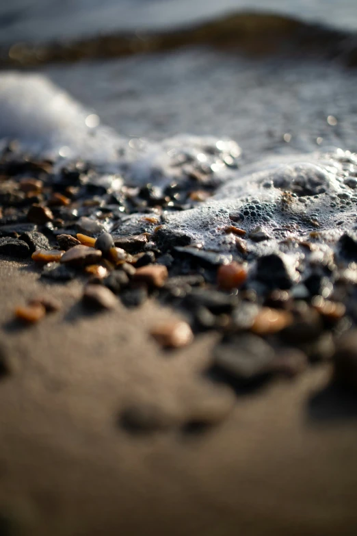 a small wave is coming onto a sandy beach