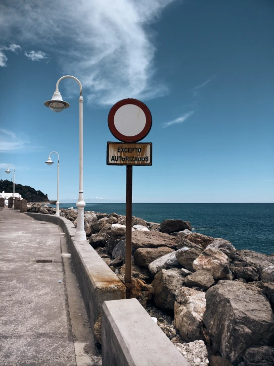 a sign that reads passion street with rocks next to it