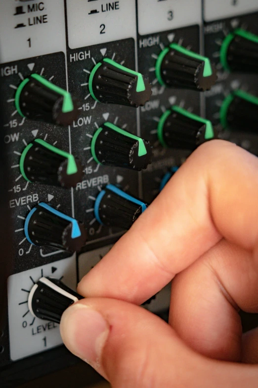 a close up of someone operating soundboard ons