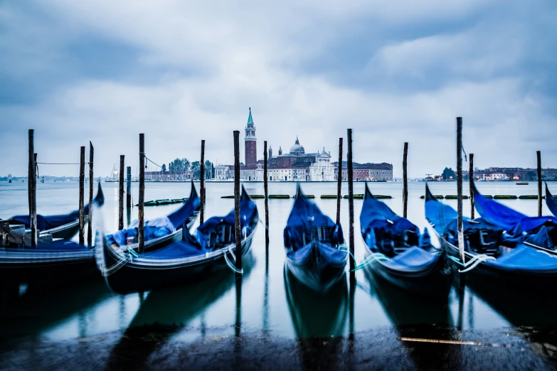 gondolas are lined up next to the pier