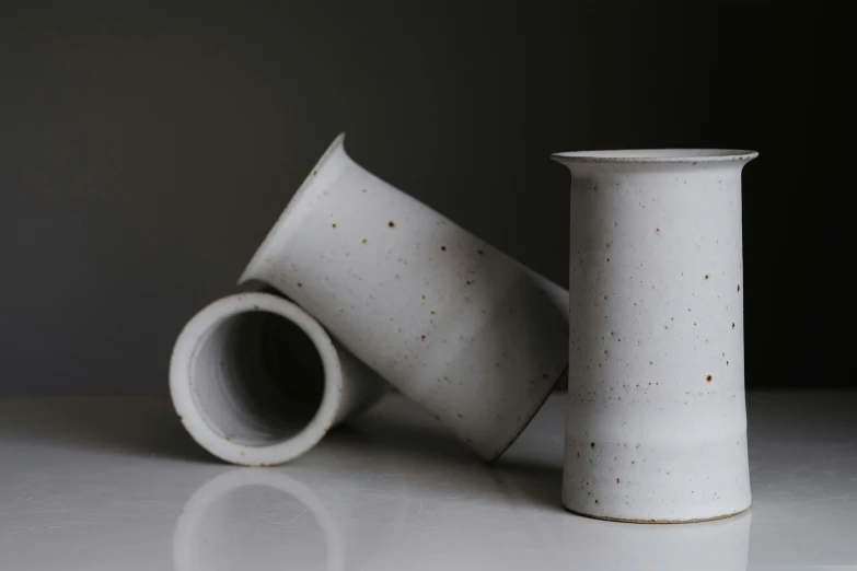 two white vases with tiny sprinkles on them