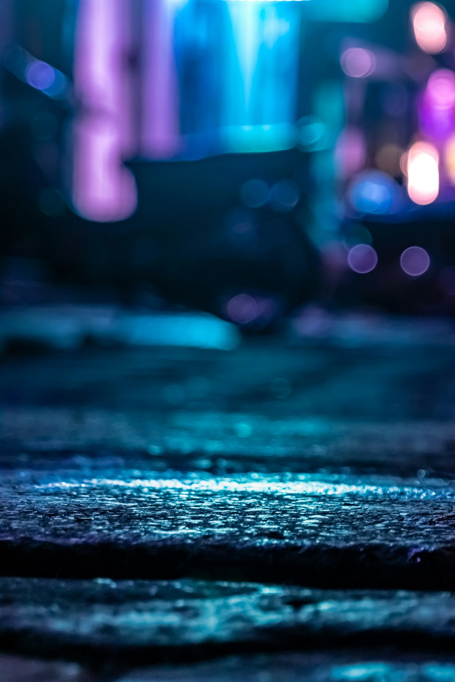 blurry po of umbrella in the rain at night