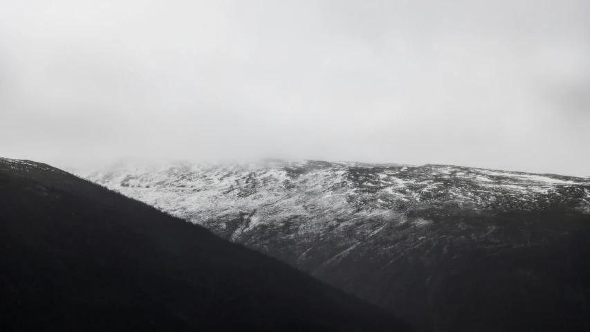 a mountain range is shown in black and white