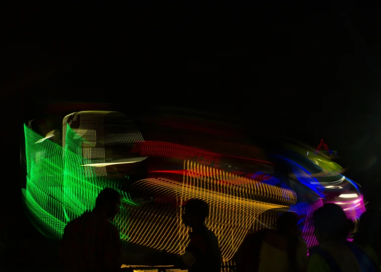 people standing on a busy street at night with lights