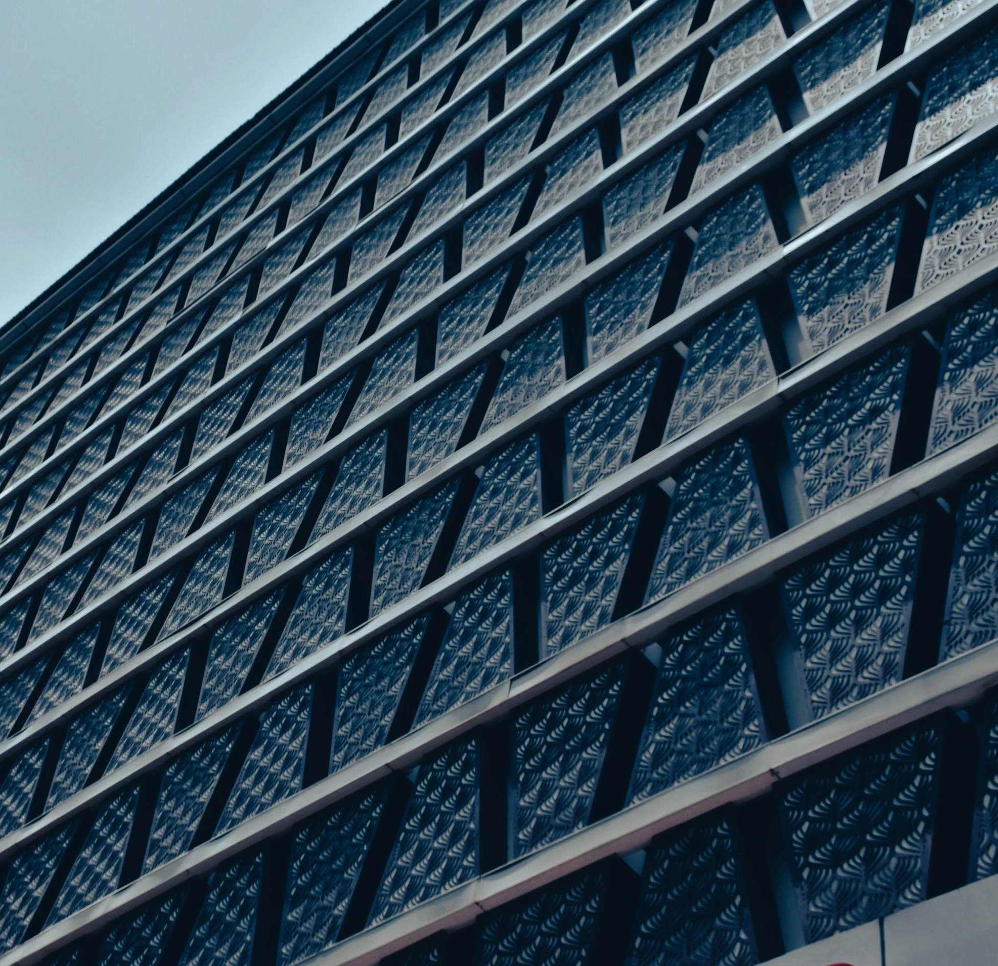 close up view of the side of a building with a clock at the top