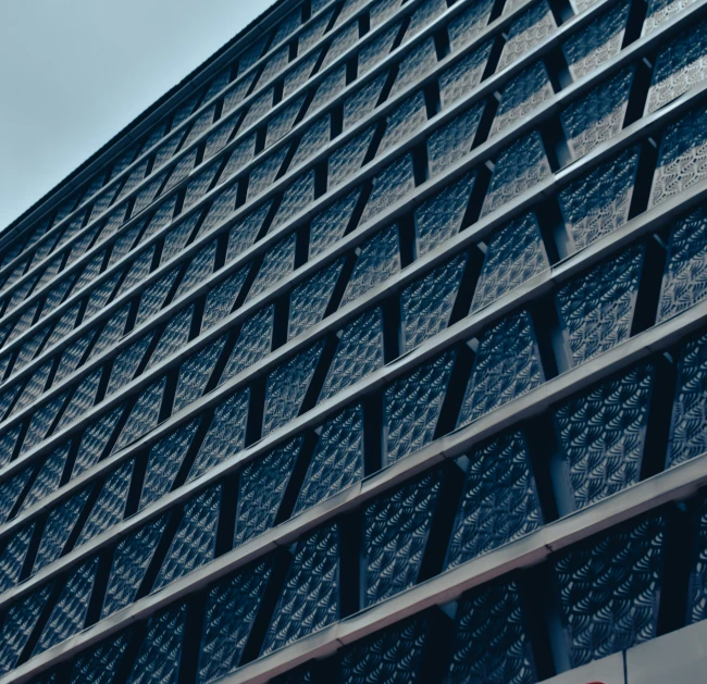 close up view of the side of a building with a clock at the top