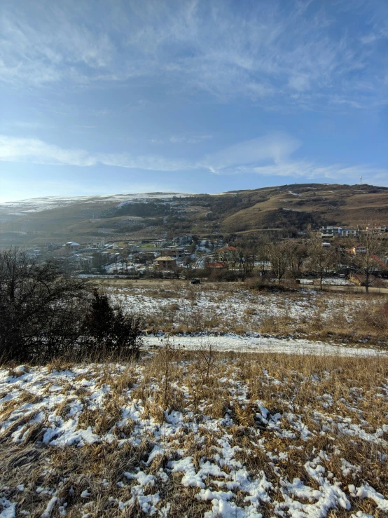 a picture of a snowy landscape with hills in the distance