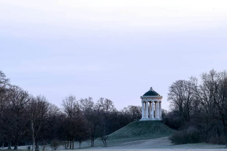 a lone building is situated between two trees