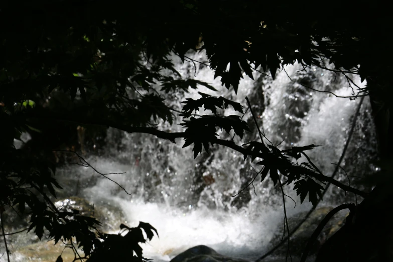 a large waterfall flowing through the sky with lots of greenery