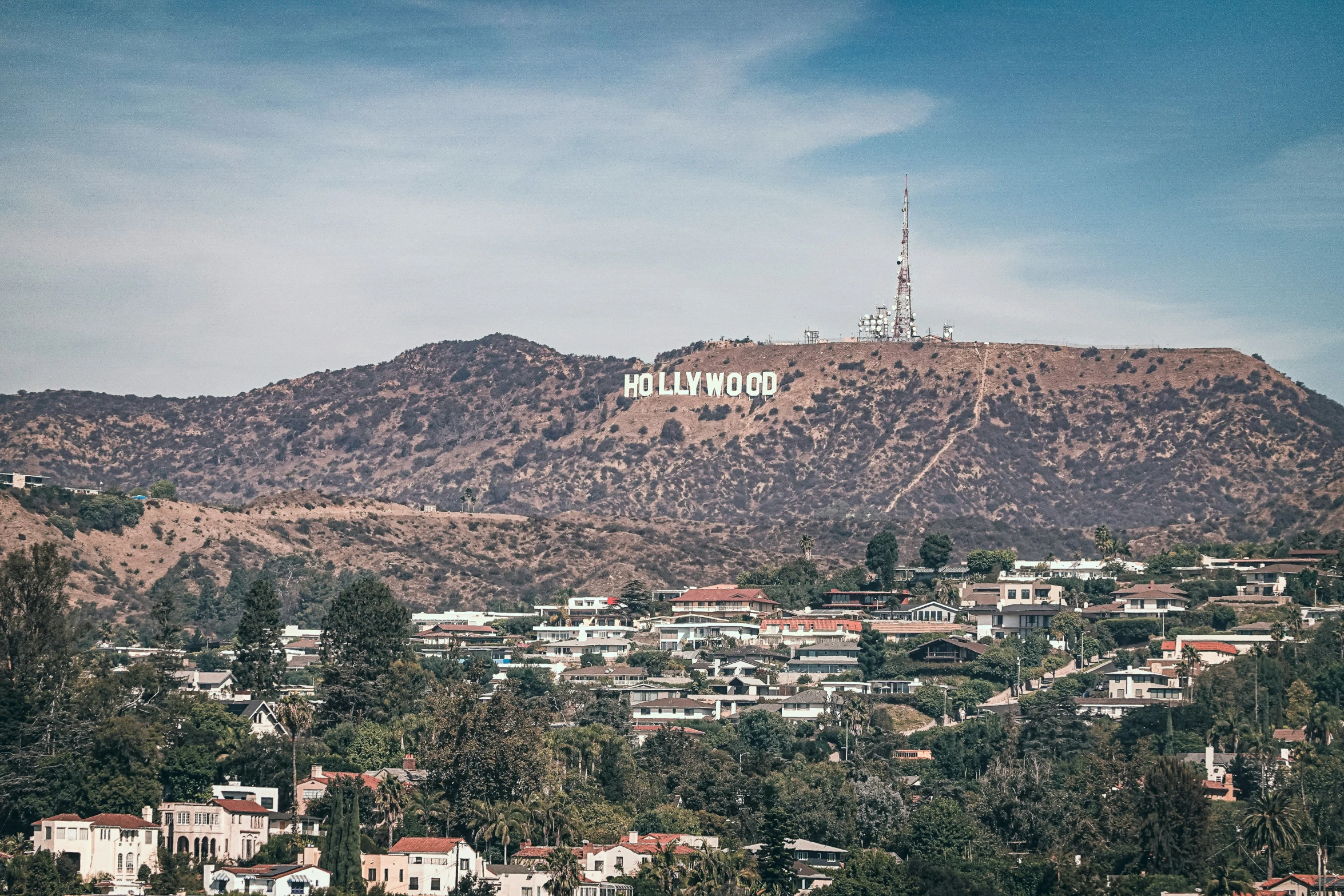 the hollywood sign is at the top of the hill