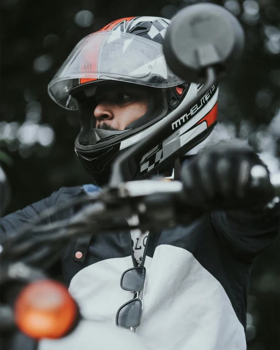 a person with a helmet and gloves standing next to a motorcycle