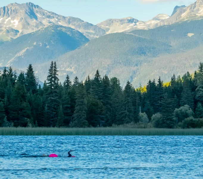 a couple of people on a pink boat in the water