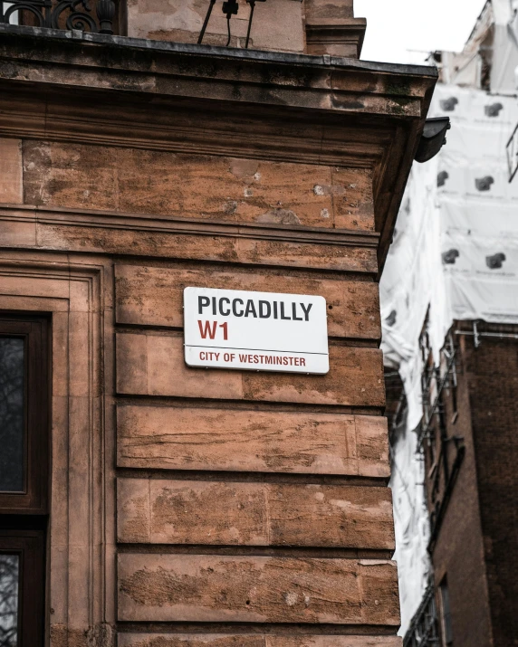 there is a city street sign on a building