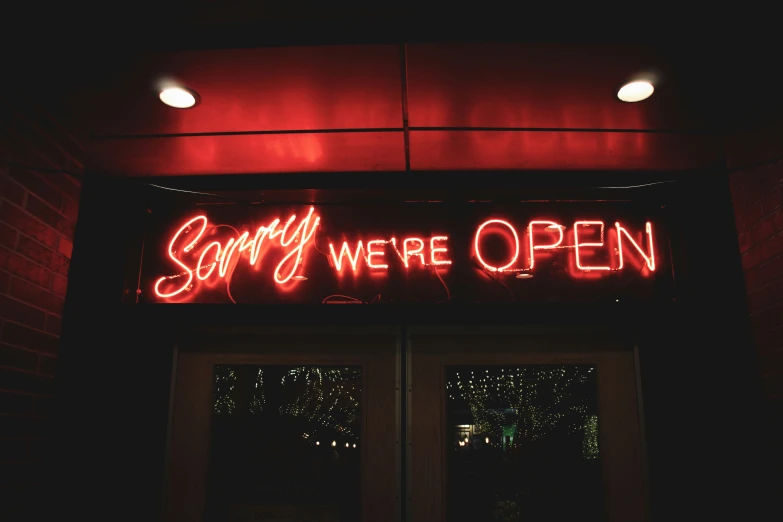 the door to the store has glowing neon signs on it