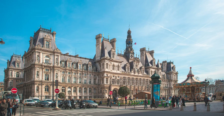 the large building with several spires is surrounded by cars