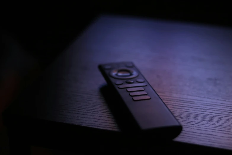 closeup of a remote control with a dark background