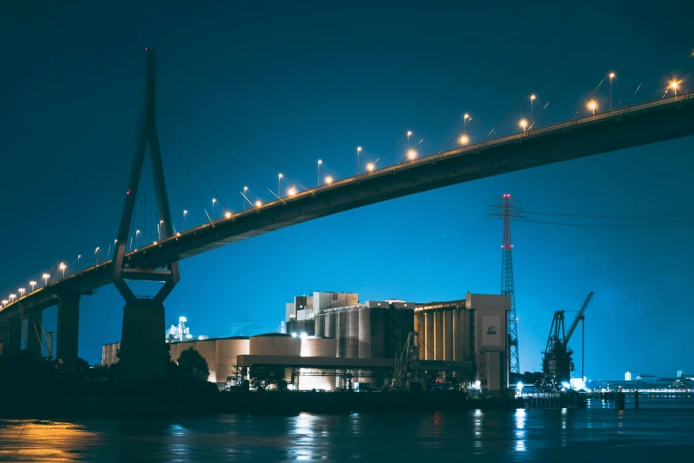 a bridge that is over some water at night