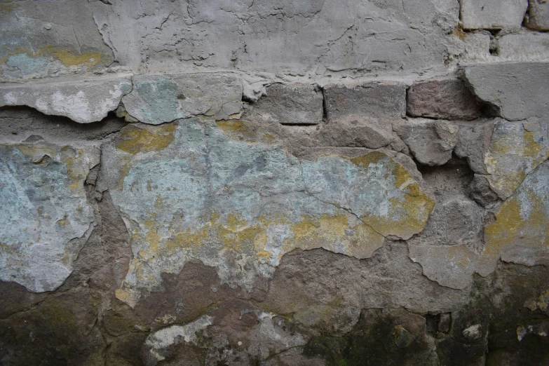 some rocks that are on a wall with white and blue paint