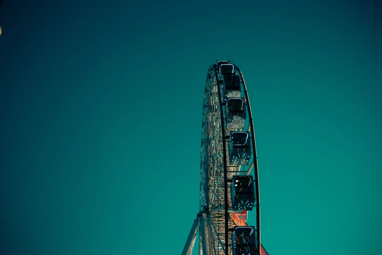 a very tall ferris wheel with a sky background