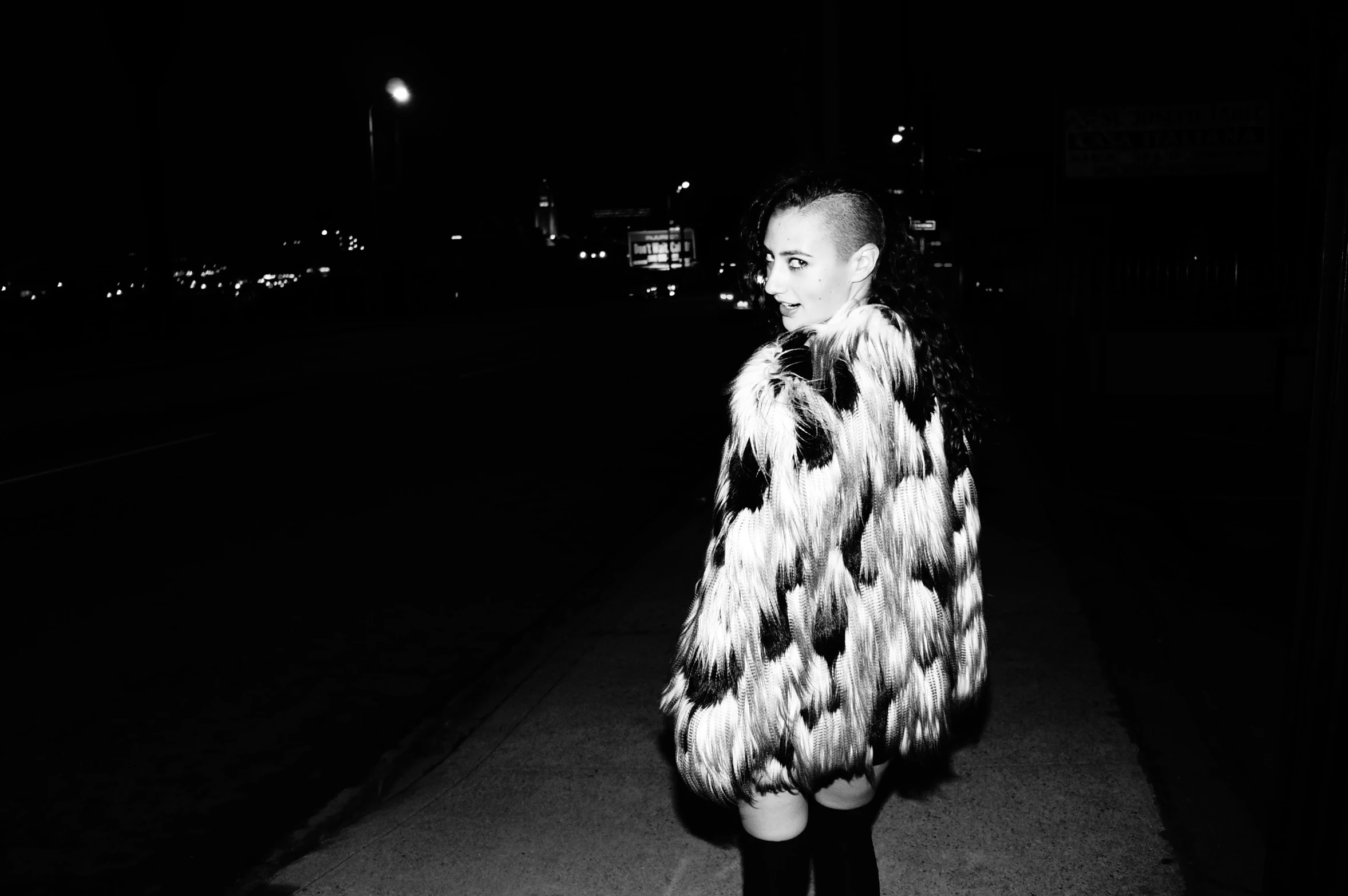 black and white pograph of a woman in fur coat