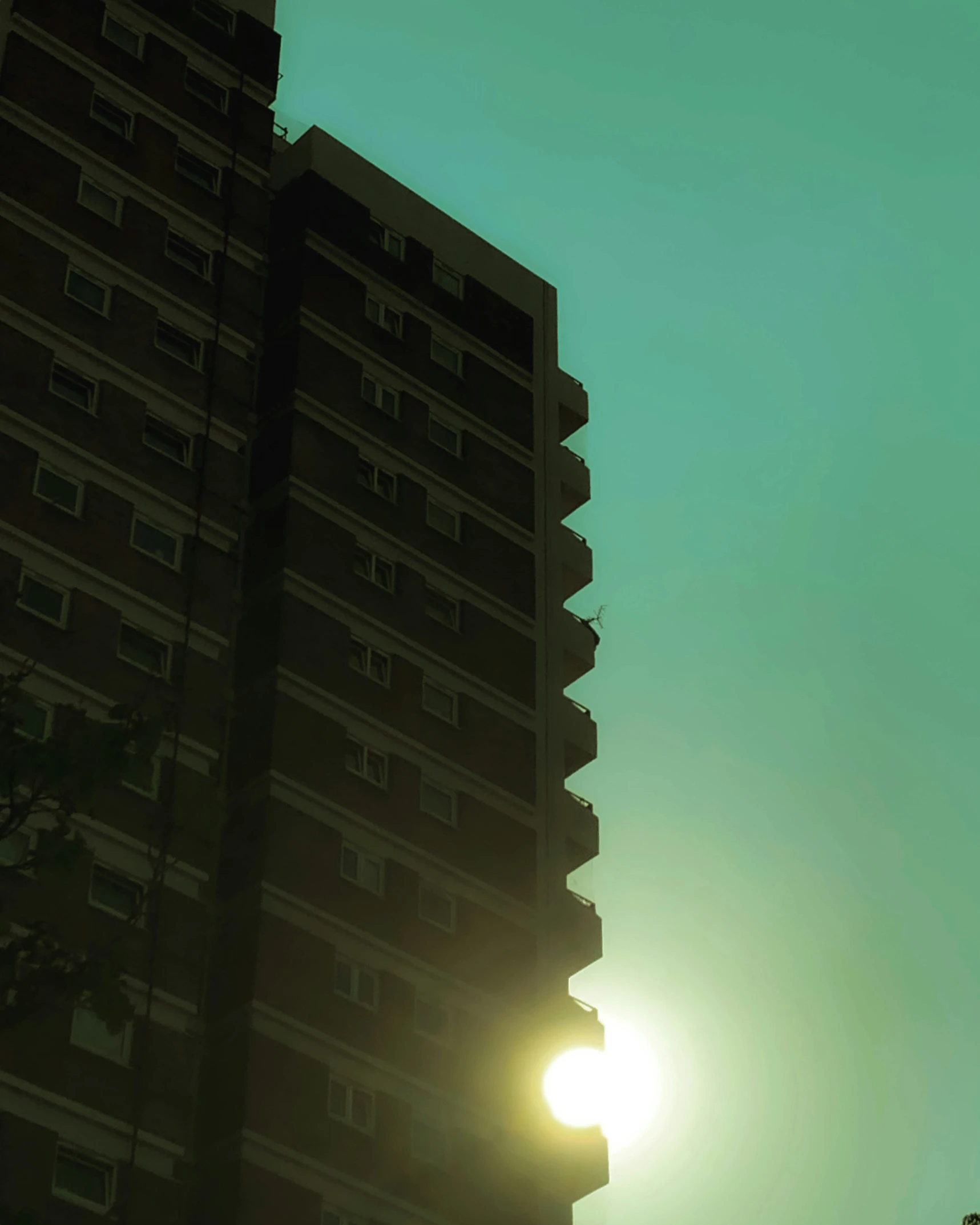 a tower is towering over the city on a sunny day