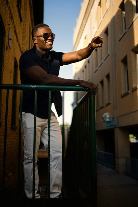 a man leaning on a balcony looking at the sky