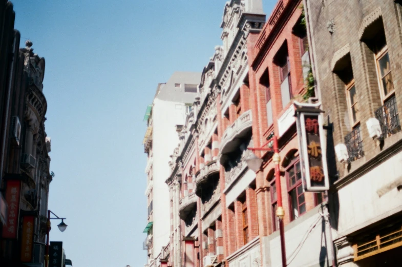 tall red brick buildings on the corner of a street