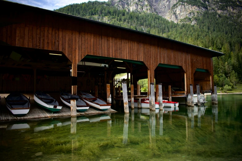 several small boats are docked on the water