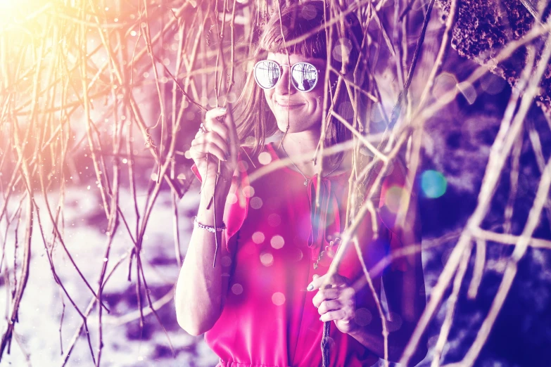 a woman holding onto a stick near some grass