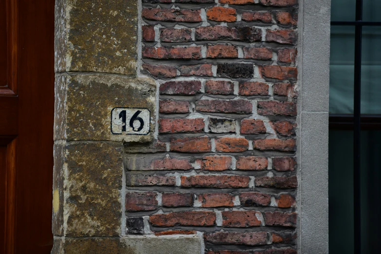 a close up view of a sign on a brick wall